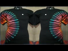 a woman's black top with multicolored patterns on the front and back