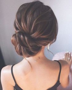 a woman with her hair in a low bun