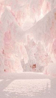 a pink and white background with snow on the ground in front of some snowy mountains