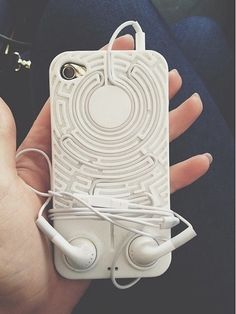 someone is holding an iphone case with headphones on it