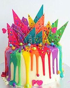 a birthday cake decorated with colorful icing and sprinkles