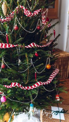 a christmas tree decorated with ribbons and ornaments