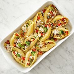 pasta with broccoli, carrots and feta cheese in a casserole dish