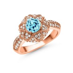 a ring with an oval blue topaz surrounded by diamonds