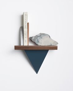 a shelf with books and a rock on it