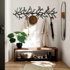 a coat rack with hats and umbrellas hanging on the wall next to a door