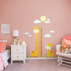 a child's bedroom with pink walls and giraffes on the wall