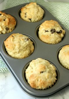 muffins in a pan on a green and white towel