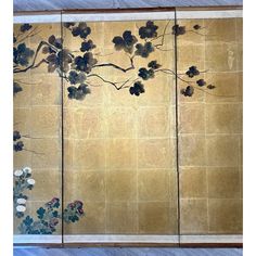 four panels with flowers and leaves painted on the side of each panel in gold, black and white