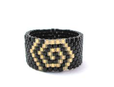 a black and gold beaded bracelet on a white background