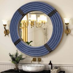 a bathroom with a sink, mirror and blue rope on the wall in front of it