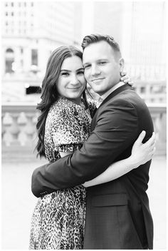 a man and woman hugging each other in the city