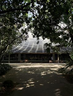 the building is surrounded by trees and grass