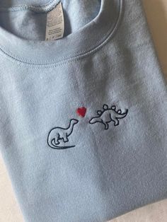 Dinosaurs In Love Embroidered Sweatshirt Cute Embroidery Shirt Ideas, Embroider Sweatshirts Ideas, Matching Dino Hoodies Couple, Embroidered Dinosaur Sweatshirt, Love Hoodie Design, Embroidery Designs Dinosaur, Cute Embroidery Designs On Hoodies, Embroidered Tshirt Mens, Dinosaur Present Ideas