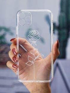 a woman holding up a clear case with flowers on it