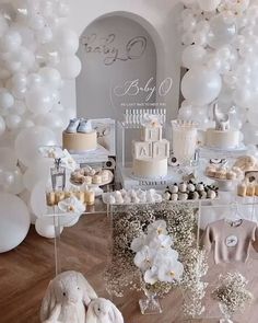 a baby shower with white balloons and decorations