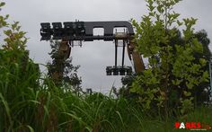 the stage is set up for an outdoor concert on a cloudy day with trees in the foreground