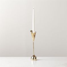 a gold candle holder with two candles in it