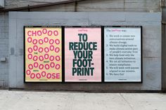 three posters on the side of a building with donuts in different colors and sizes