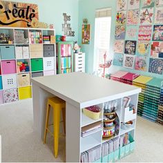 a room filled with lots of crafting supplies and storage space next to a window