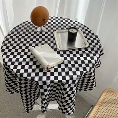 a black and white checkered table cloth with a book on it