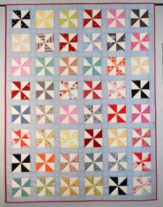 a colorful quilt hanging on the wall