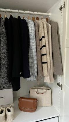 an organized closet with shoes, sweaters and handbags