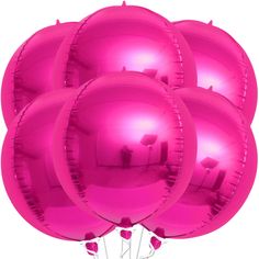 large pink balloons are arranged in the shape of a ballon with candles on them