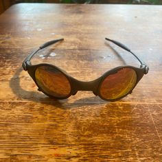 a pair of sunglasses sitting on top of a wooden table