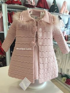 a pink coat is on display in a store