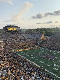 a football stadium filled with people watching the game