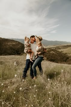 a man, woman and child are standing in a field