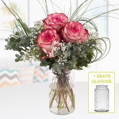 a vase filled with pink roses and baby's breath