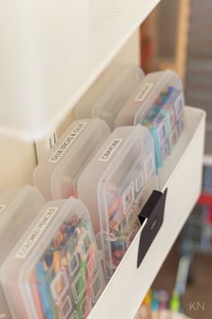 the drawers are filled with different types of pens and pencils in plastic storage containers