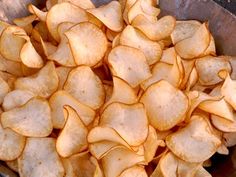 a bowl full of potato chips sitting on top of a table