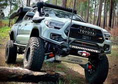 a toyota truck is parked in the woods