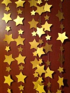 some gold stars hanging from the side of a door