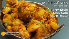 a metal bowl filled with food on top of a table next to a sign that says party style aloo gobi