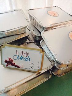 there are many silver trays that have food in them on top of each other