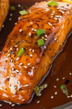 salmon with sesame seeds and green onions in a brown sauce