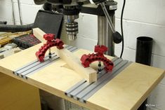 a machine that is working on some kind of thing in the middle of a workbench