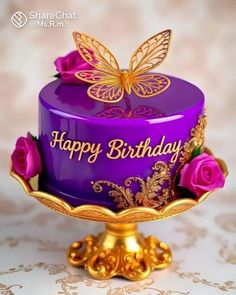 a purple birthday cake with gold butterflies on top and pink roses in the bottom tier