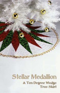 there is a christmas tree skirt with bells on the bottom and red, white and green leaves