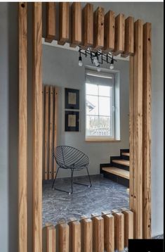 a room that has some kind of wooden structure on the wall and stairs in front of it