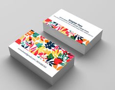 two business cards designed to look like colorful flowers and leaves, both with the same color scheme