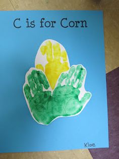 a child's handprinted card with the words c is for corn