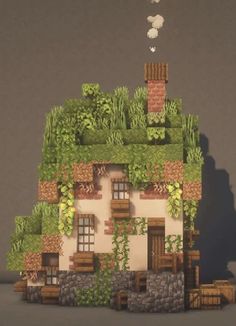 a small house with plants growing on the roof