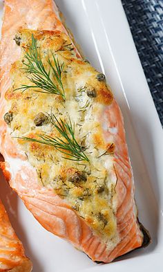 a white plate topped with salmon and potatoes