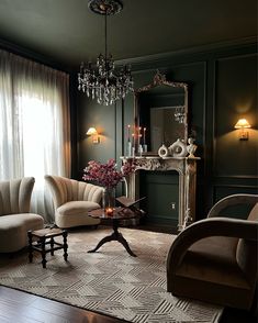 a living room filled with furniture and a chandelier hanging from the ceiling next to a window