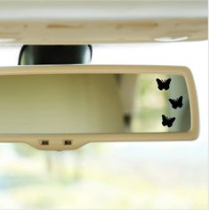 a rear view mirror with three butterflies on it